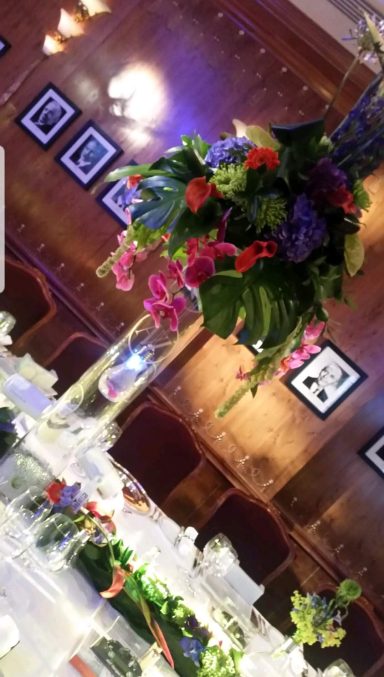 Vibrant floral centrepiece above a beautifully arranged dining table.