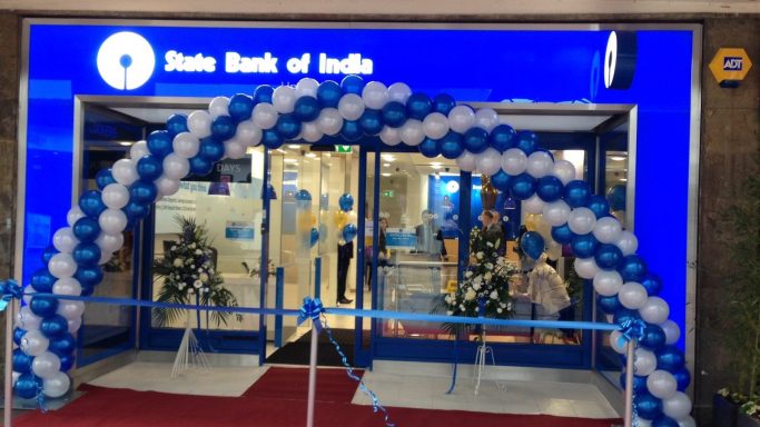 Entrance of State Bank of India decorated with blue and white balloons.