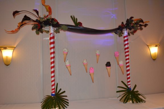Decorative display featuring colourful ice cream cones and tropical leaves.